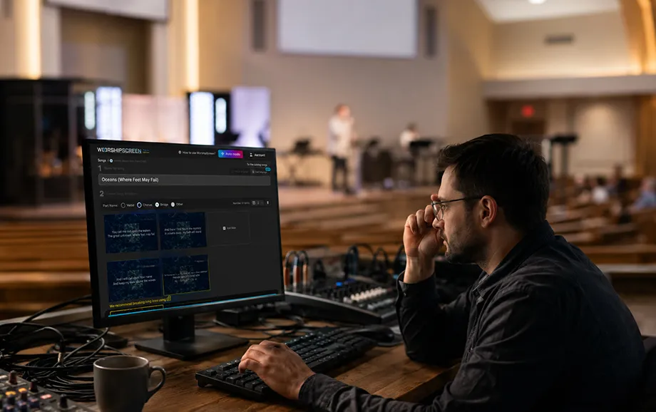 Volunteer reviewing presentation slides on a monitor before a church service